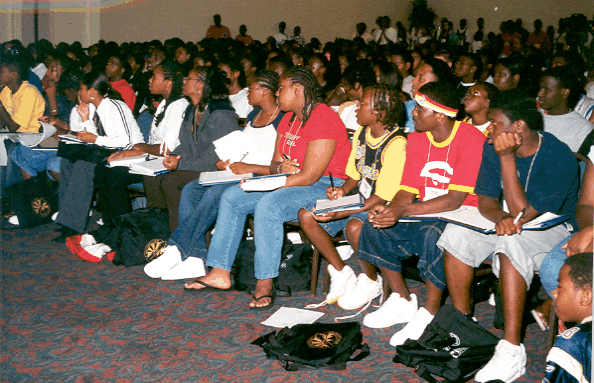 Group of teenagers in the audience watching a seminar